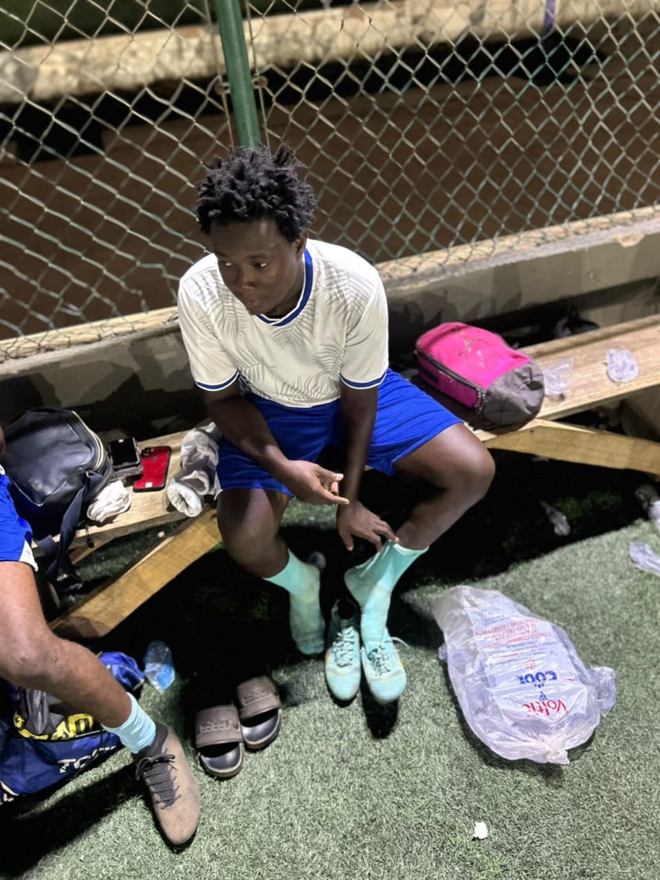 A player putting on his boots before a match
